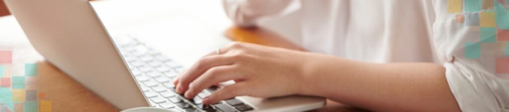 Woman typing on a laptop.