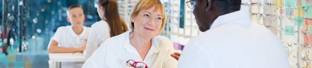 An optometrist helping a patient find frames