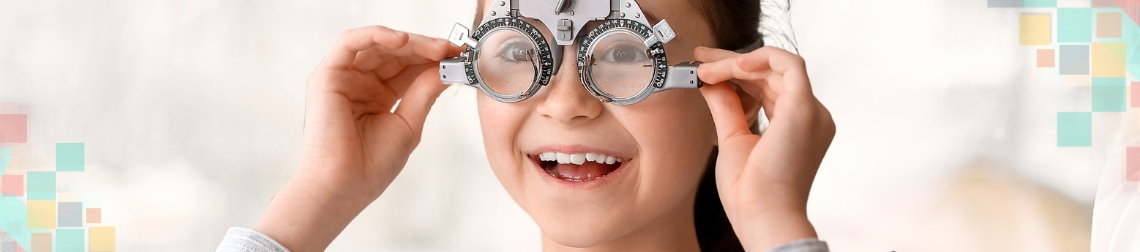 Child holding eye exam device.