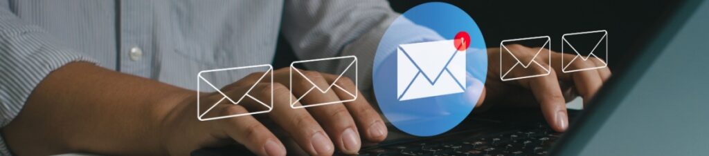Hands typing on a laptop with an email icon showing one new message