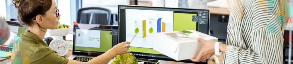 People looking at branding assets on a computer screen.